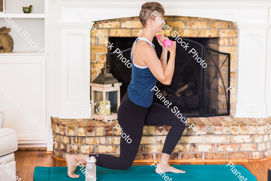 A young lady working out at home stock photo with image ID: 0074994e-2373-4c14-bab2-6230cf04c43d