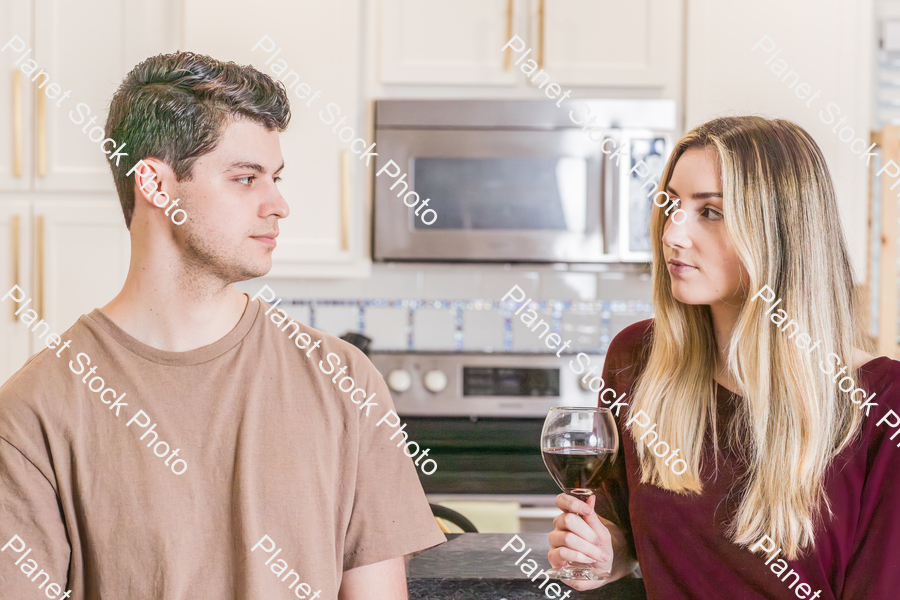 A young couple sitting and enjoying red wine stock photo with image ID: 03d6f207-c0ec-48b6-8848-6db033ec905d