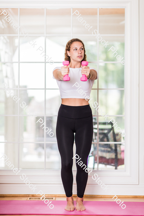 A young lady working out at home stock photo with image ID: 07cc122b-6abb-4938-8967-f7afe2da3567