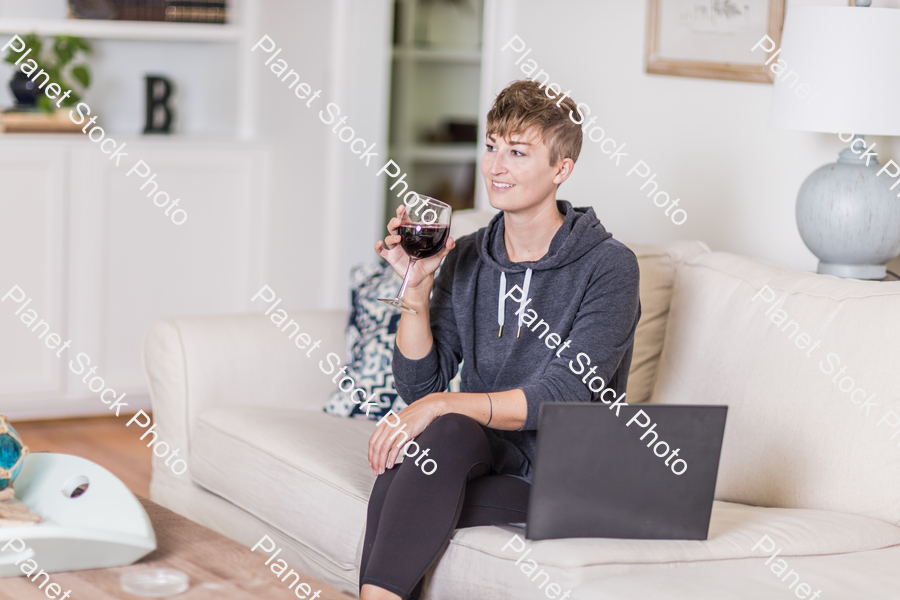 A young lady sitting on the couch stock photo with image ID: 0821b607-1f18-429f-8b42-1a0e59bc2675