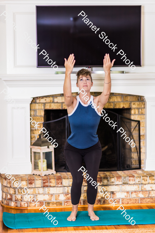 A young lady working out at home stock photo with image ID: 0a9ec0e6-5c9c-40aa-93ac-cc0e04a391b2