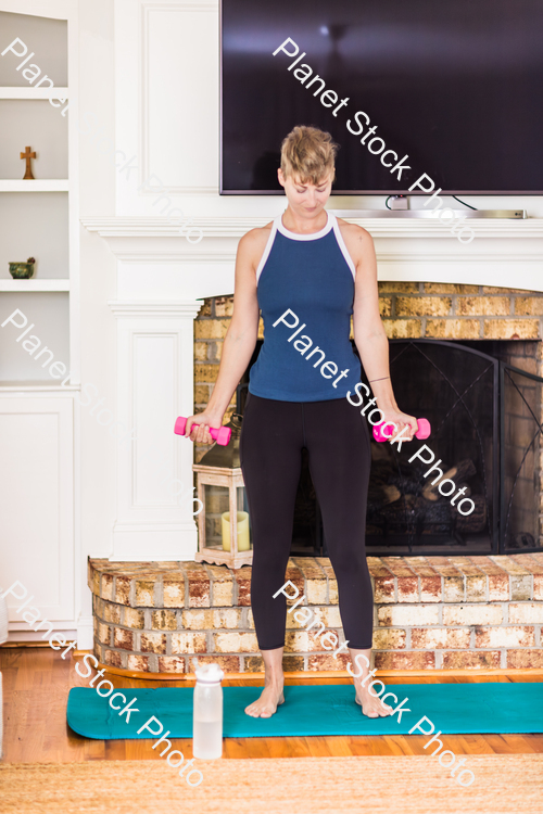 A young lady working out at home stock photo with image ID: 0bc27c52-f530-4d67-b98f-944845051492