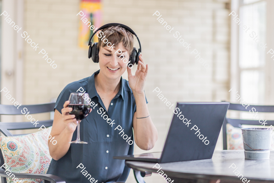 A young lady enjoying daylight at home stock photo with image ID: 0d7617ed-d863-4b5c-bb41-2c1510e4e93d