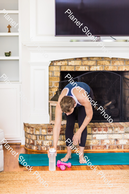 A young lady working out at home stock photo with image ID: 104d8033-3327-4e60-98a5-5460eb4184b8