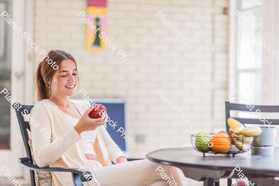 A young lady enjoying daylight at home stock photo with image ID: 120169fe-2258-4026-be42-b6c08f90b719