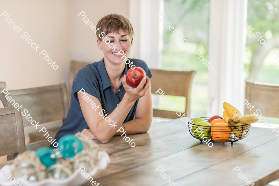 A young lady grabbing fruit stock photo with image ID: 1334d8a3-a5ae-442e-8872-cdcd56ef55fb