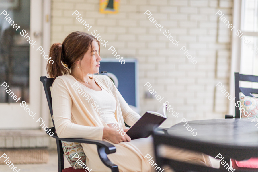 A young lady enjoying daylight at home stock photo with image ID: 1373cbde-9205-4948-ac8d-bc74e1699660