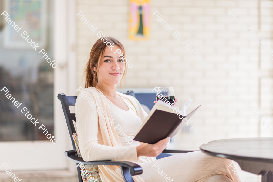 A young lady enjoying daylight at home stock photo with image ID: 16617c87-8eeb-44d5-a0da-44471db3e8a6