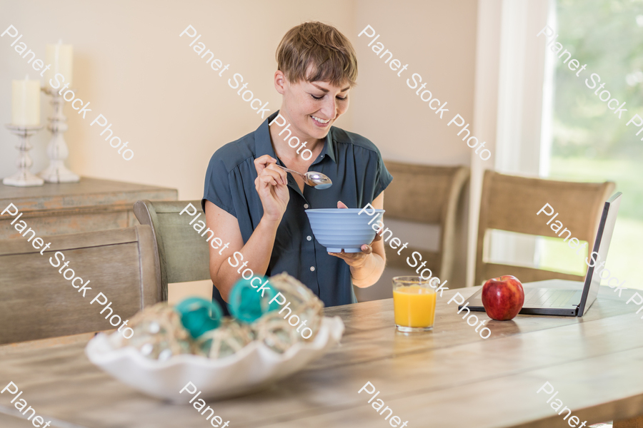 A young lady having a healthy breakfast stock photo with image ID: 17a2873e-cee7-47b9-9ae6-fa06b37ed4d0