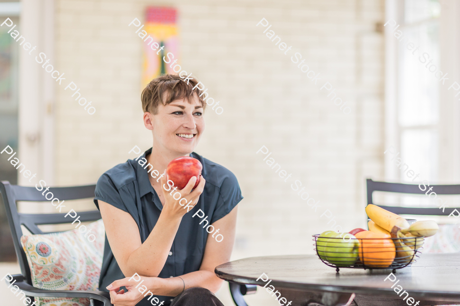 A young lady enjoying daylight at home stock photo with image ID: 17c3e2c5-e980-4d36-a6f2-f5e7d0978a05