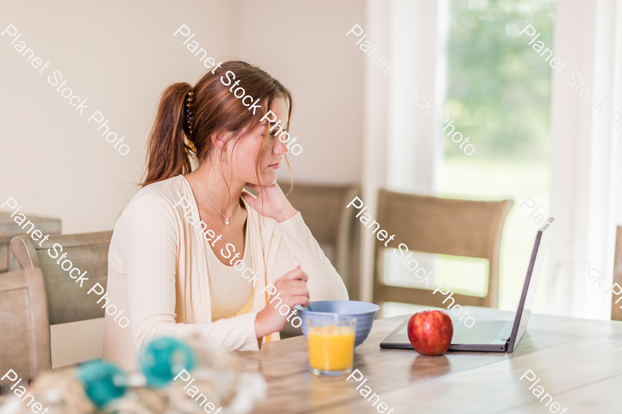 A young lady having a healthy breakfast stock photo with image ID: 18fb352b-debf-4449-a90d-7abd4e56f6f1