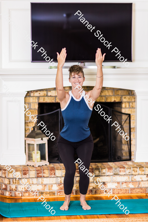 A young lady working out at home stock photo with image ID: 198824b4-c679-4b43-a923-8cd79e0baec4