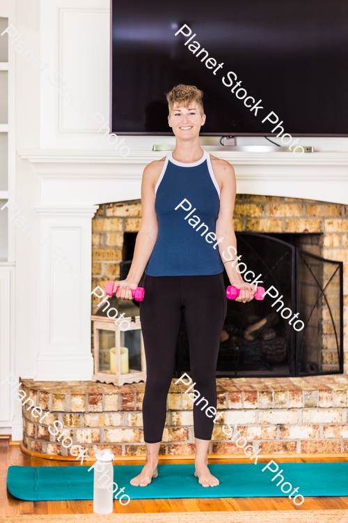 A young lady working out at home stock photo with image ID: 1a09da6e-1428-4b66-80d4-8ca742884998