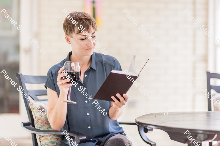 A young lady enjoying daylight at home stock photo with image ID: 1baa6172-b78c-4347-8f20-fd4bae8c5f31