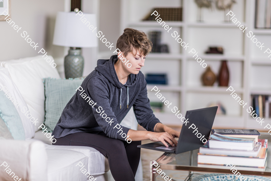 A young lady sitting on the couch stock photo with image ID: 20a646a8-7ef7-4f2d-ab40-594f5d155281