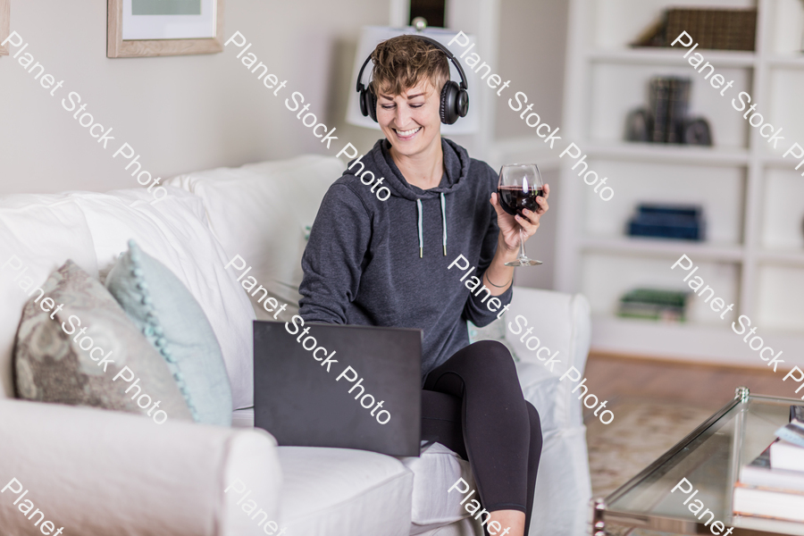 A young lady sitting on the couch stock photo with image ID: 229f6a24-c1c9-4ab9-9e6d-b085f28d94a1