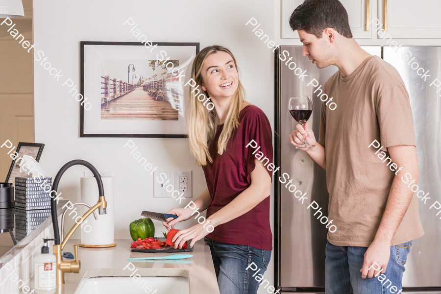 A young couple preparing a meal in the  kitchen stock photo with image ID: 22a263d6-dac7-4897-879b-064492e5167f