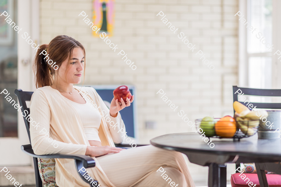 A young lady enjoying daylight at home stock photo with image ID: 22adda2f-2152-47bc-b40a-eac1ea82dc95