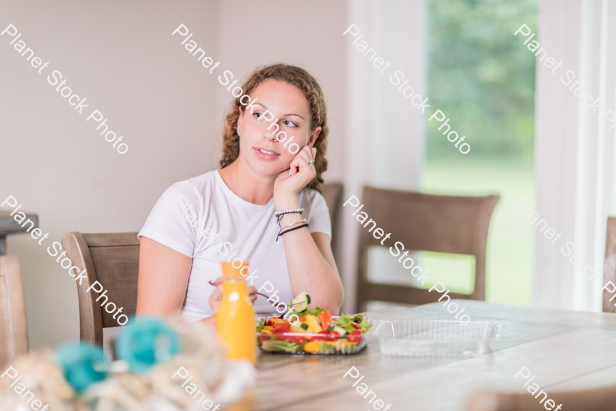 A young lady having a healthy meal stock photo with image ID: 22cb3684-b57a-471e-9c85-04109805488e