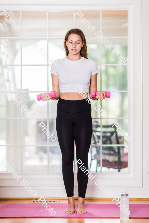 A young lady working out at home stock photo with image ID: 23ad11ef-14cb-464a-aefe-1231296df997