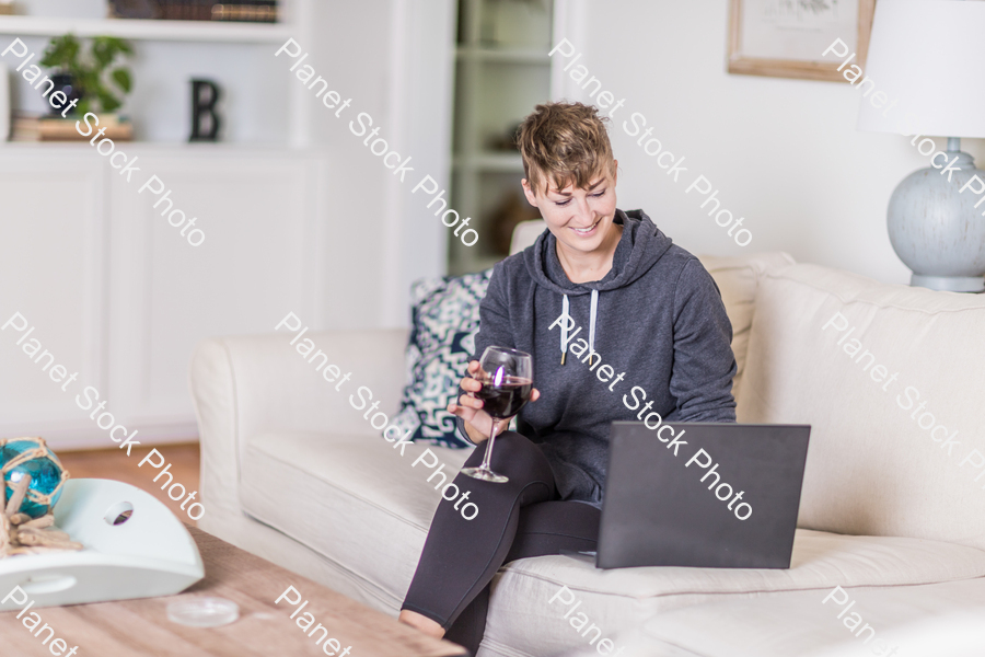 A young lady sitting on the couch stock photo with image ID: 2693e6ea-3c00-40ac-a3f5-2d5954b017a6