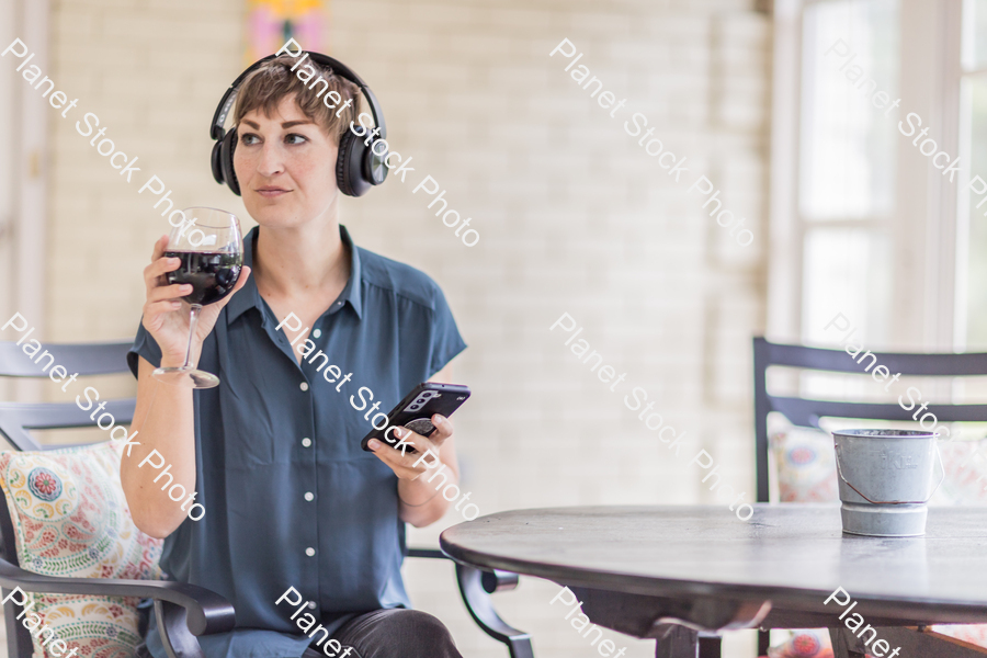 A young lady enjoying daylight at home stock photo with image ID: 2862fd6f-67a8-4042-9f37-461b83a7435a