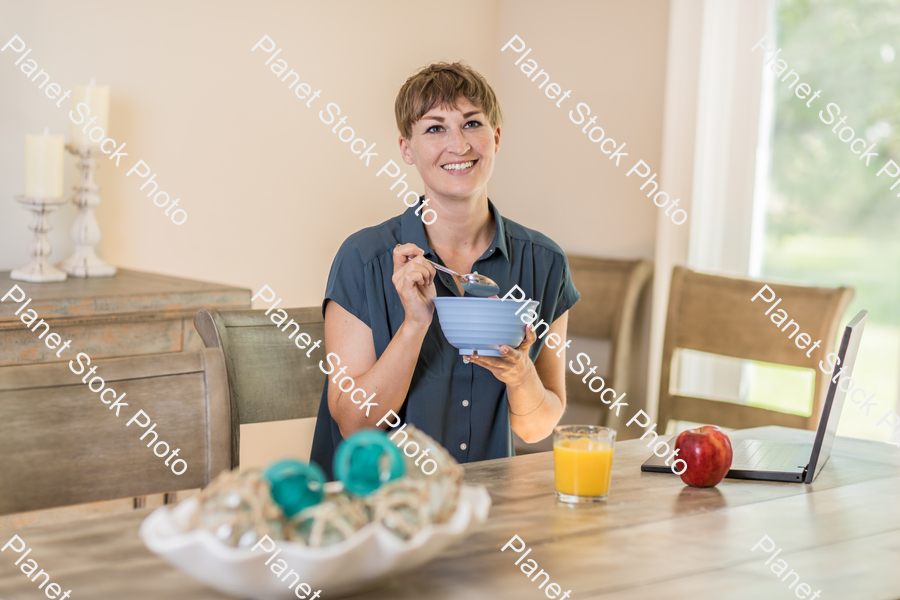 A young lady having a healthy breakfast stock photo with image ID: 28c5793a-fa49-4667-9b80-d16c10967de7