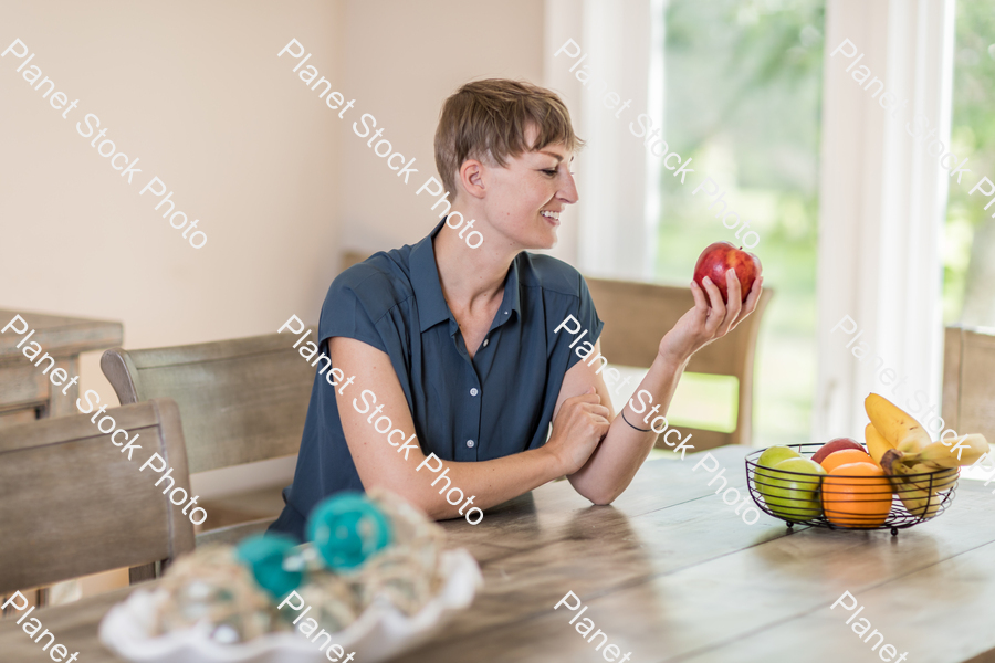 A young lady grabbing fruit stock photo with image ID: 28f9bf19-da95-47ad-90ad-f23e4fc44fd6