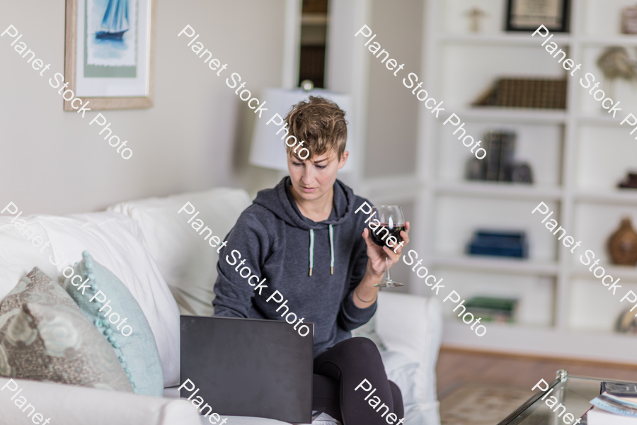 A young lady sitting on the couch stock photo with image ID: 2ac5dbcf-19a3-42a7-b45b-0ddf8bc73ce0