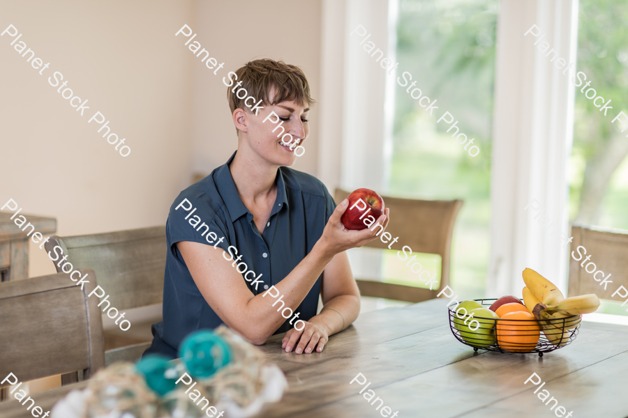 A young lady grabbing fruit stock photo with image ID: 2ac88b74-3014-446a-870a-902785d53cf3