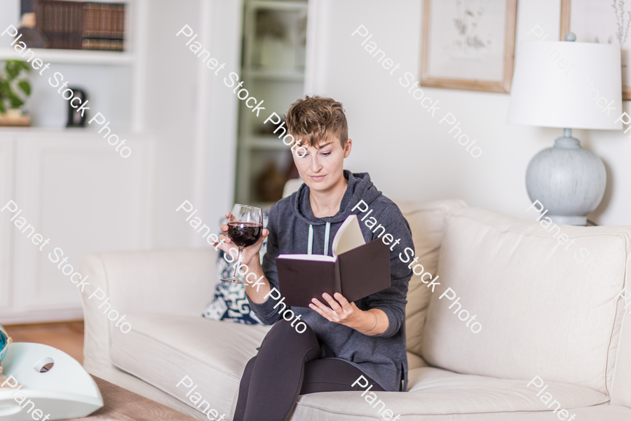 A young lady sitting on the couch stock photo with image ID: 2af83073-6a25-43ad-9306-2c5856bc41b5