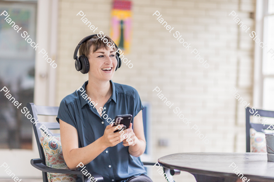 A young lady enjoying daylight at home stock photo with image ID: 2bbf2969-524f-46a0-95f4-04b4e5eb3302