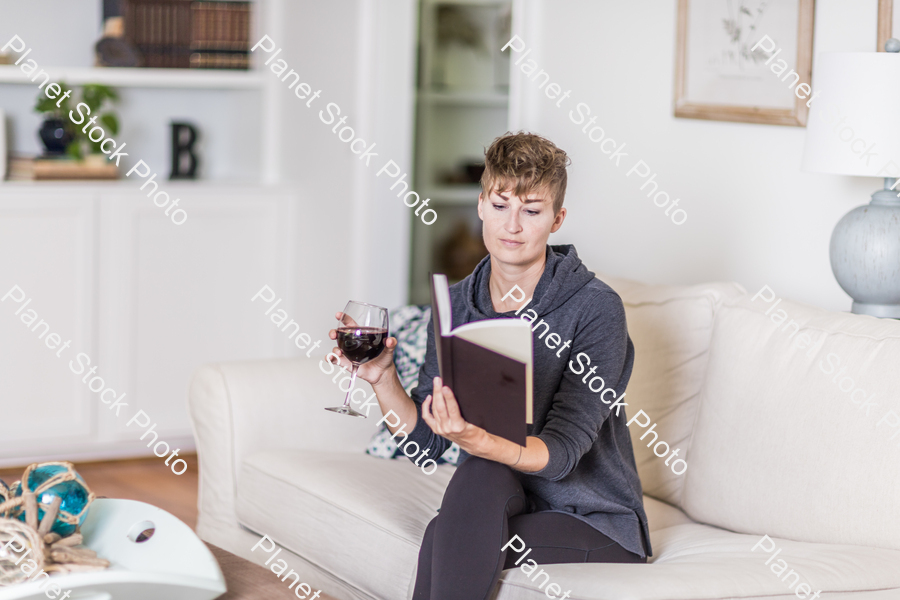 A young lady sitting on the couch stock photo with image ID: 2c47c808-f0b5-4b8f-a103-0a72a20ecd8e