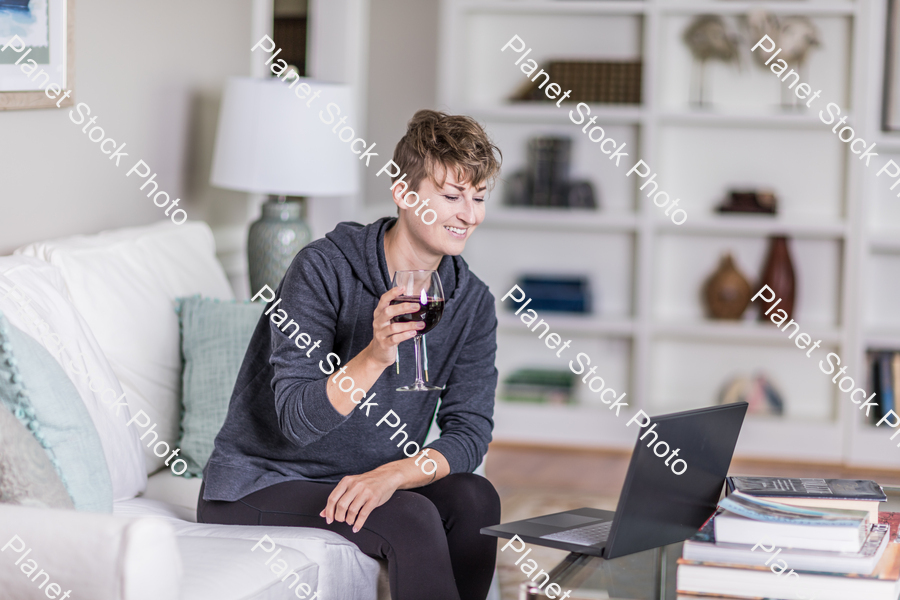 A young lady sitting on the couch stock photo with image ID: 2dfd4f6d-21a4-4c7c-8fa1-fc551d6a0dec