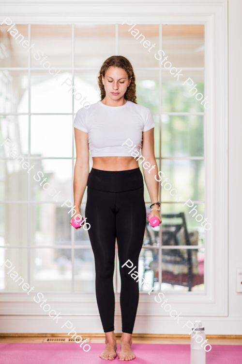 A young lady working out at home stock photo with image ID: 2fa5e6b2-ac6a-4521-a5f5-2e994e202a2e