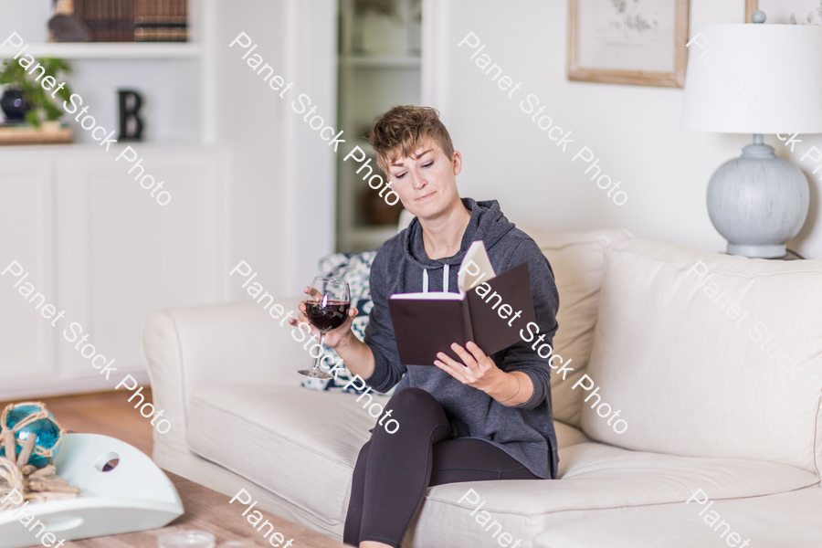 A young lady sitting on the couch stock photo with image ID: 318b427a-a6d2-424b-8beb-eb01043aaa46
