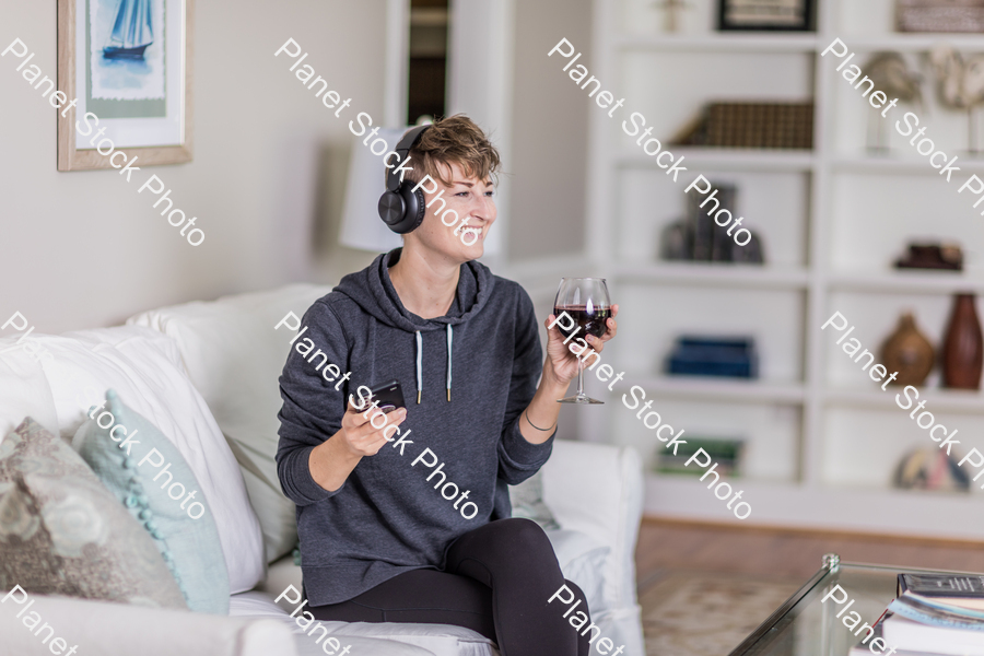 A young lady sitting on the couch stock photo with image ID: 31bef006-a411-4a3b-8a9f-408f5a273d2b