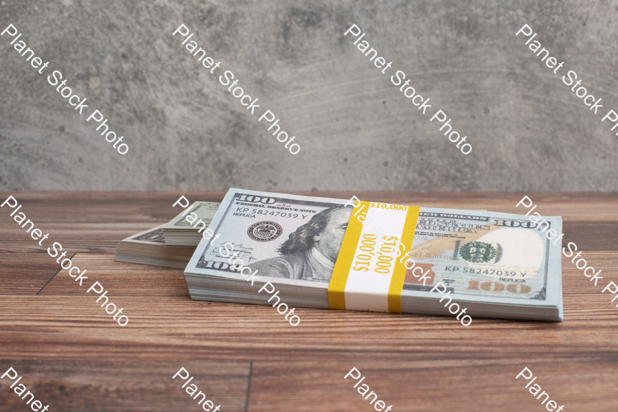 Three stacks of dollar bills stock photo with image ID: 31c147a4-00cc-4291-ba3a-9bc3ef7c3254