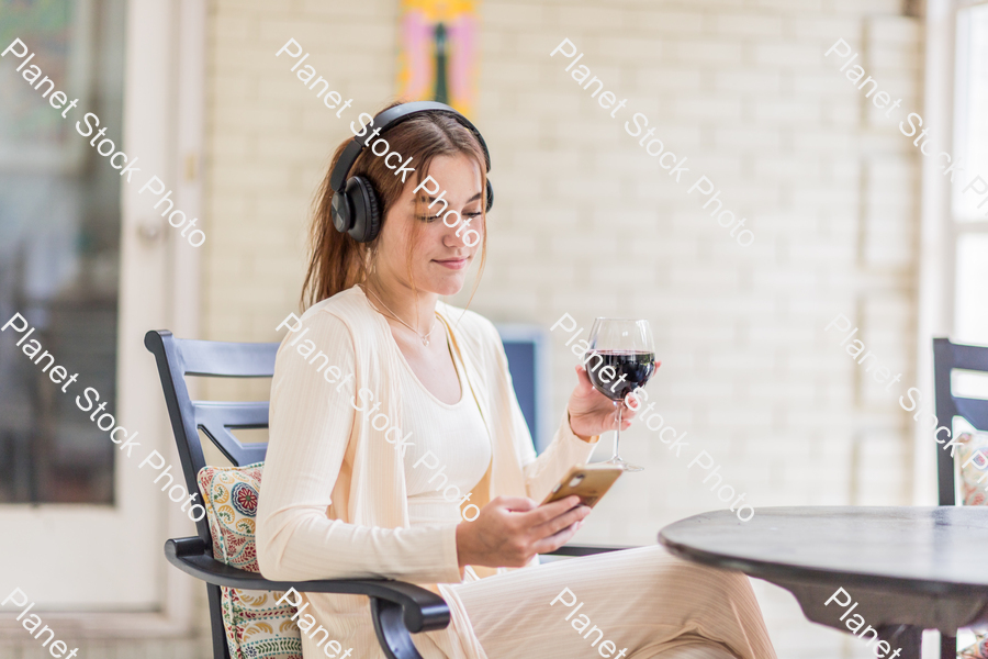 A young lady enjoying daylight at home stock photo with image ID: 31d5f93f-8ea8-43dd-9185-ea4e1275dd01