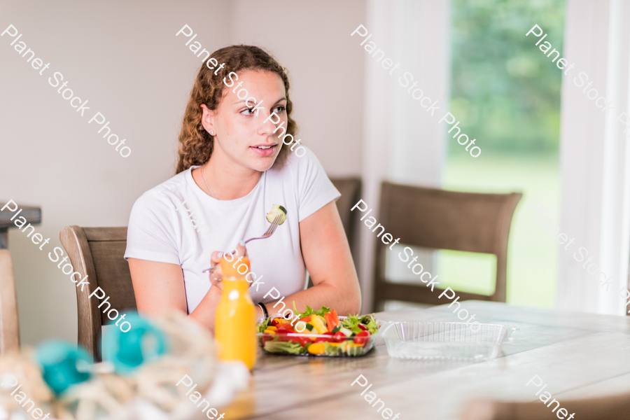 A young lady having a healthy meal stock photo with image ID: 321d1da1-81f7-4ed0-b06a-080e107e8ffd