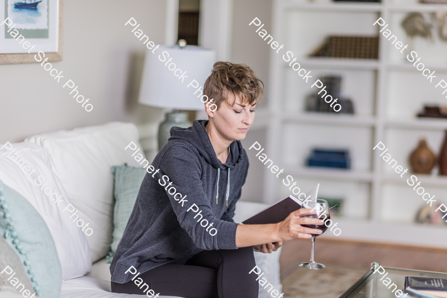 A young lady sitting on the couch stock photo with image ID: 328a5753-7c0f-4ec0-ab68-4d0ed8983267