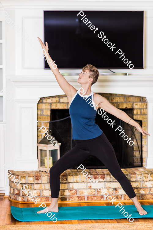 A young lady working out at home stock photo with image ID: 32d24c25-2acc-4f39-b2e1-364ea2b52f5f