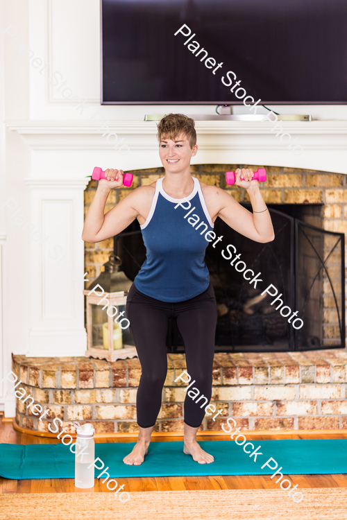 A young lady working out at home stock photo with image ID: 34d02840-0c8b-4fc7-b695-0eab833e8edc