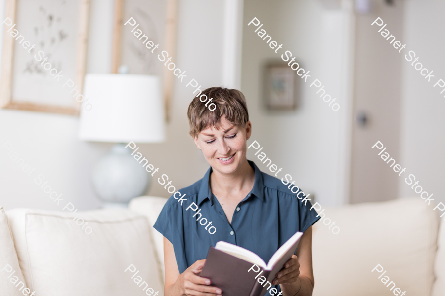 A young lady sitting on the couch stock photo with image ID: 3511e65e-714a-4149-b5da-4793ec65dff1