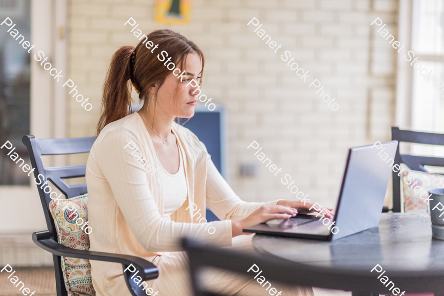 A young lady enjoying daylight at home stock photo with image ID: 359617d0-d653-46ab-8116-3bc63f03ff2b