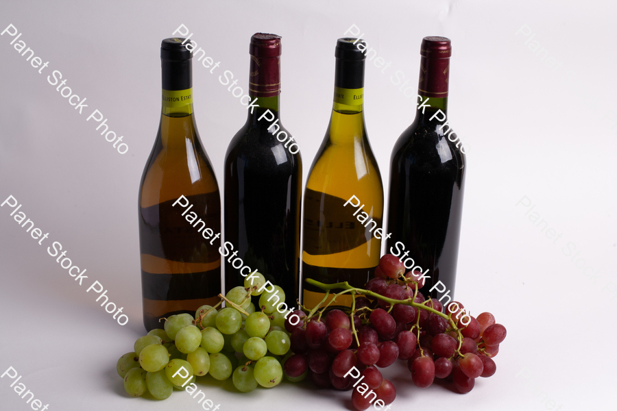 Four bottles of wine, with grapes stock photo with image ID: 35ef9c7c-9c89-4f55-912a-ffb2ea9014bc