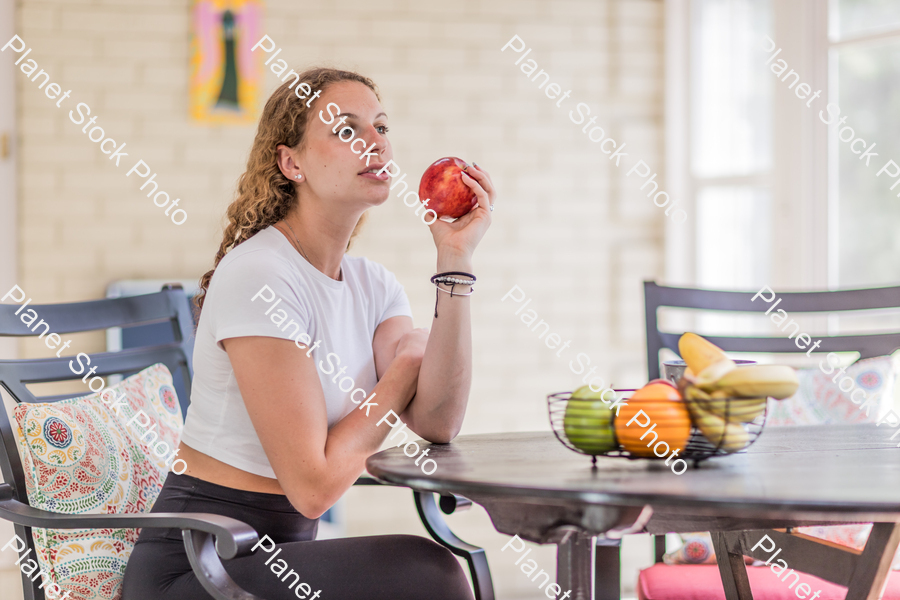 A young lady enjoying daylight at home stock photo with image ID: 36a1026b-9adb-4ddf-a7fa-f1faef200fe4