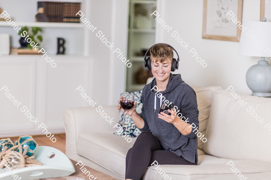 A young lady sitting on the couch stock photo with image ID: 377b33ea-2a0b-4021-bf52-4cd005825539