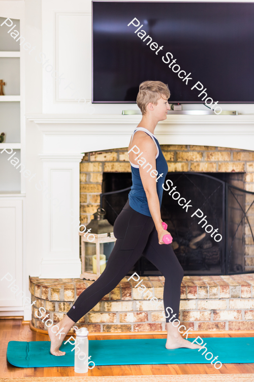 A young lady working out at home stock photo with image ID: 383caf87-c4d0-4e00-8484-2af0cd7fe45f