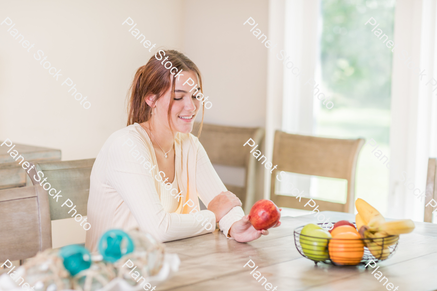 A young lady grabbing fruit stock photo with image ID: 3910db30-56cf-4db6-abb2-159dcdad9d14